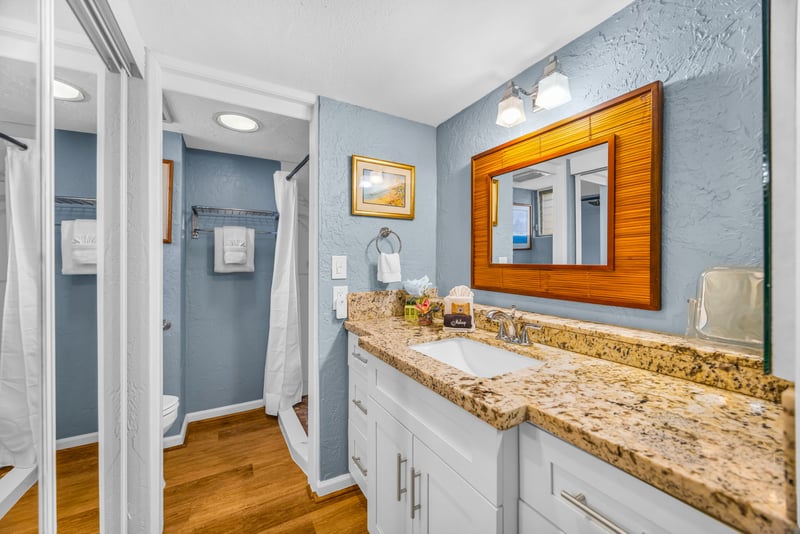 The bath features a spacious countertop, perfect for getting ready