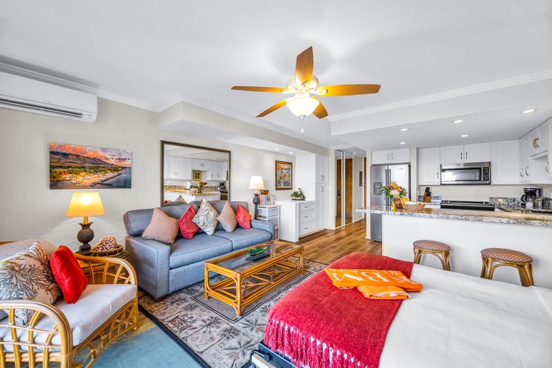 The living area opens toward the lanai with a comfortable sofa and rattan accents