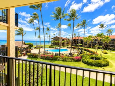 Step onto the balcony and take in a wide ocean panorama framed by tropical greenery