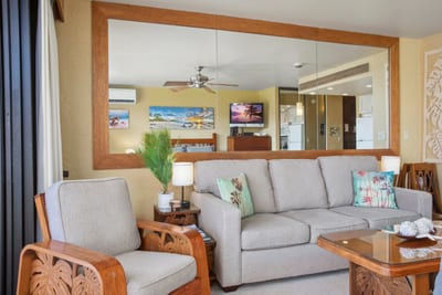 Polished wood details and soft island hues make this living room feel like a warm invitation to slow down and unwind