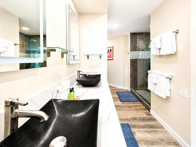 The primary bath features dual washbasins for added convenience