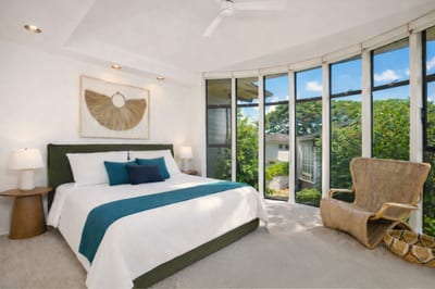 A modern canopy of light wraps this calming retreat, where soft bedding meets lush garden whispers