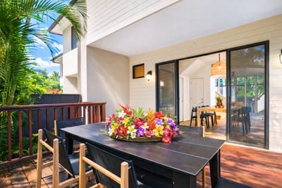 Savor meals al fresco on this private lanai, where modern comfort meets a tranquil canopy of island greenery