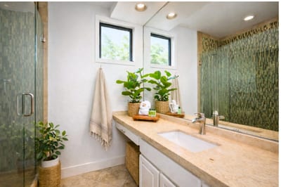 This tranquil master bath features a walk-in glass shower with custom mosaic tile and a serene, spa-like ambiance