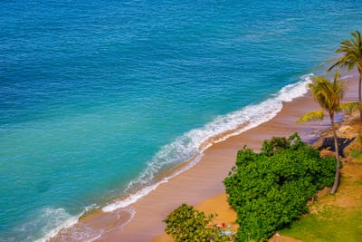 Swim, snorkel, or sunbathe at the sandy beach just below your private lanai.