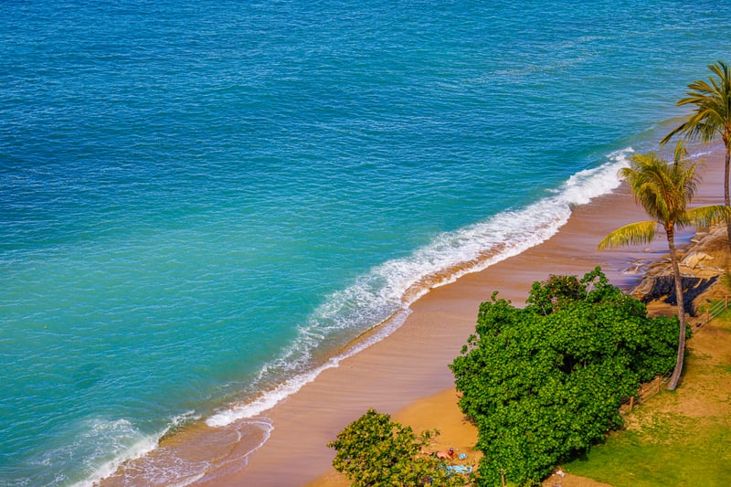 Swim, snorkel, or sunbathe at the sandy beach just below your private lanai.