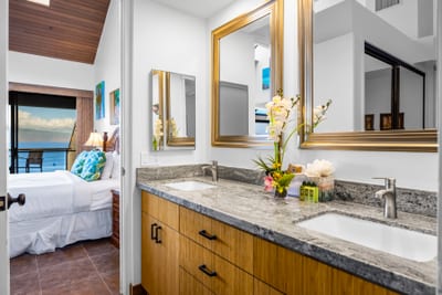 Fresh flowers and elegant details make the primary bath feel like your own island spa.