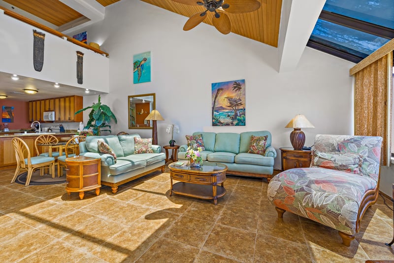 Open-concept living with plush seating, vaulted ceilings, and ocean views creates an inviting space to gather and relax.