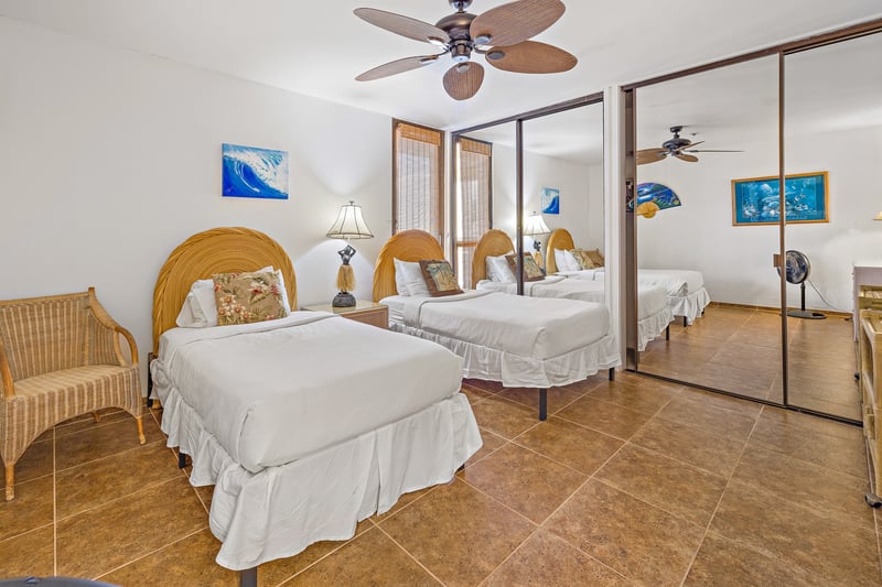 A third bedroom with two Twin beds and ceiling fan offers flexible sleeping for kids or guests.