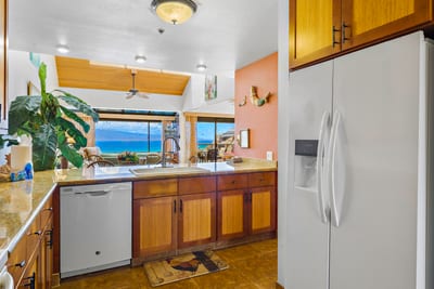 Prepare meals with ease in your fully equipped kitchen featuring granite countertops and custom cabinetry.
