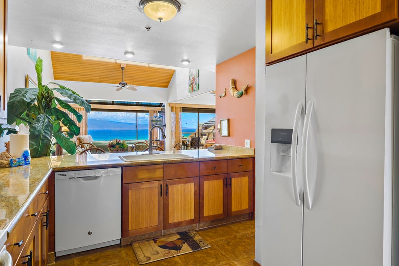Prepare meals with ease in your fully equipped kitchen featuring granite countertops and custom cabinetry.