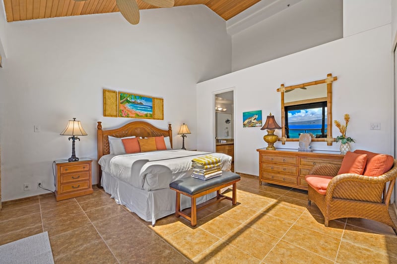Your spacious primary suite features a King bed, seating area, and direct access to your private lanai.