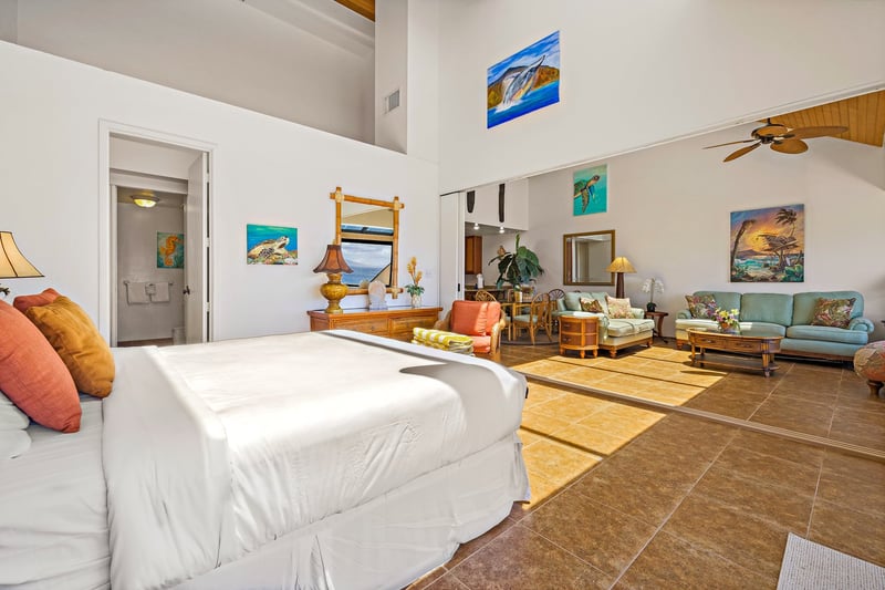 Vaulted ceilings and warm wood tones create a luxurious, open feel in the King primary bedroom.