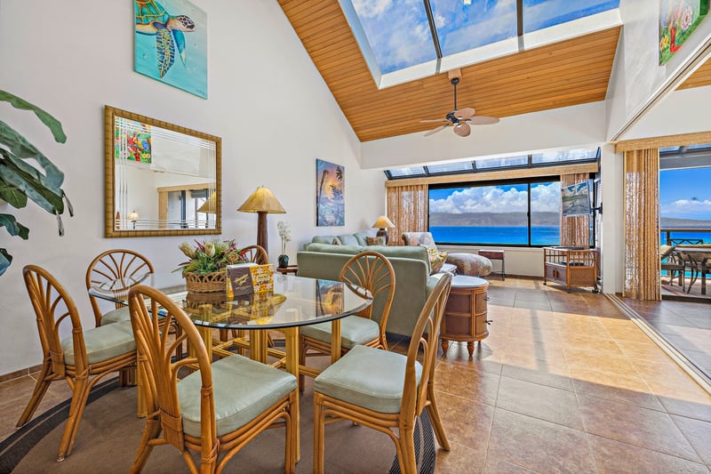 The living area blends indoor comfort with natural light and tropical surroundings, plus a sofa sleeper for extra guests.