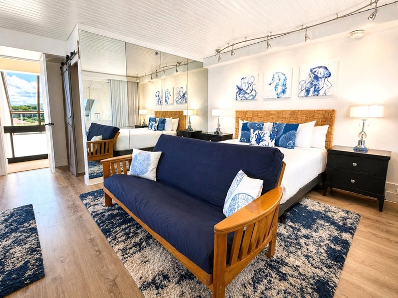 Guest bedroom with a sofa seating area and floor to ceiling mirrors