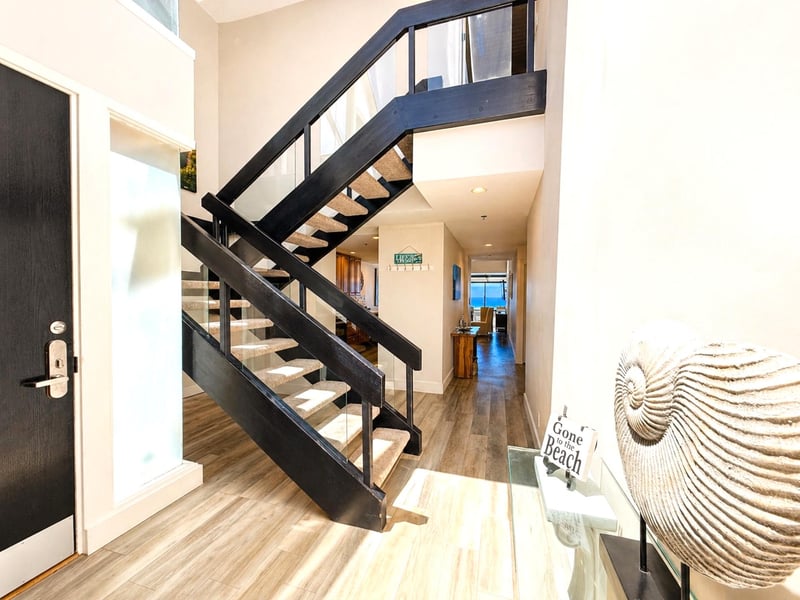 A staircase entry adds architectural character and leads guests naturally into the heart of the villa