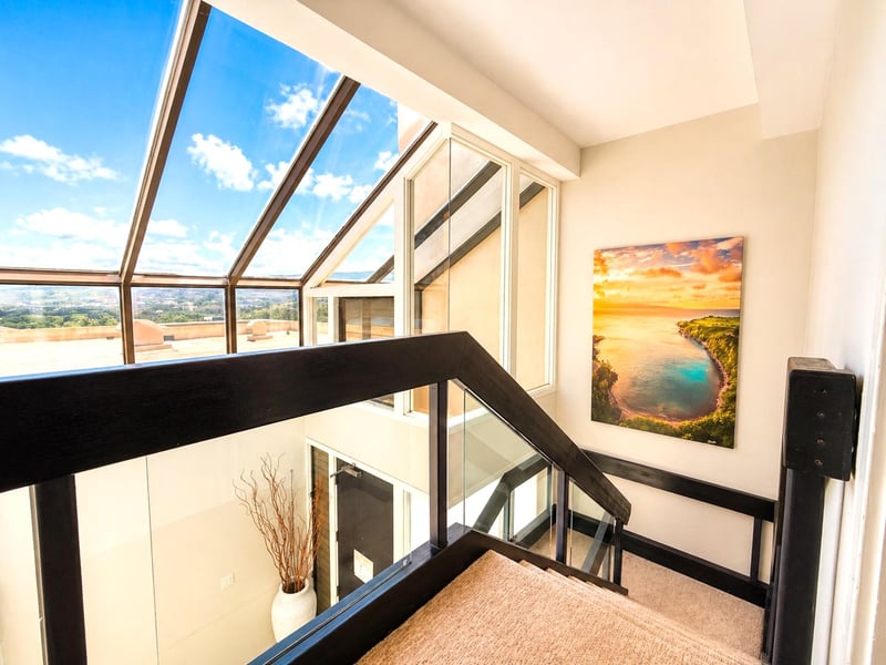 A welcoming entryway with artwork and above head windows