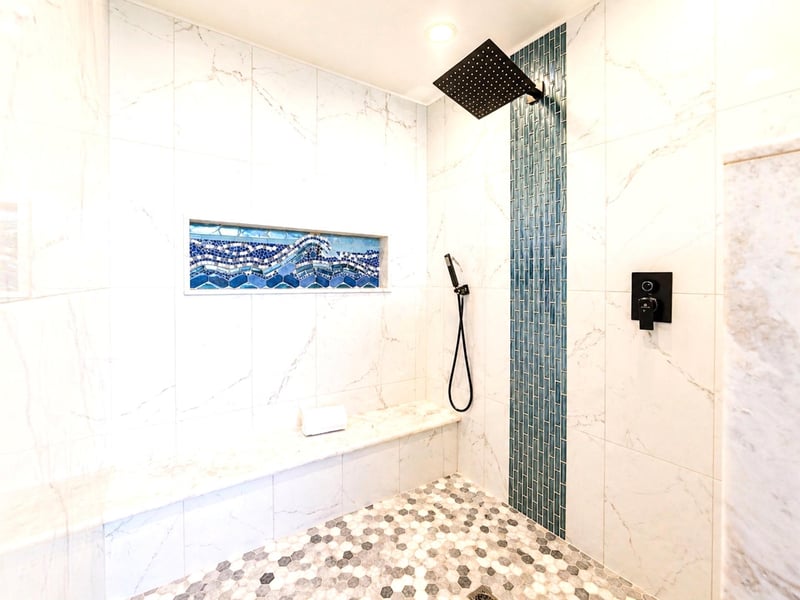 The primary bath features a walk-in shower and a separate handheld shower head