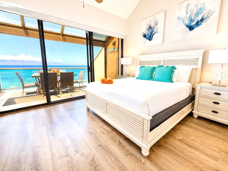A spacious primary bedroom with a king bed, thoughtful furnishings, and a calm, resort-inspired atmosphere