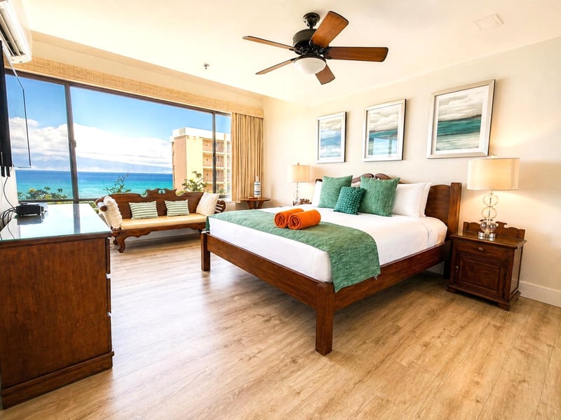 The first guest bedroom offers a comfortable, well-lit sleeping space with gorgeous ocean views