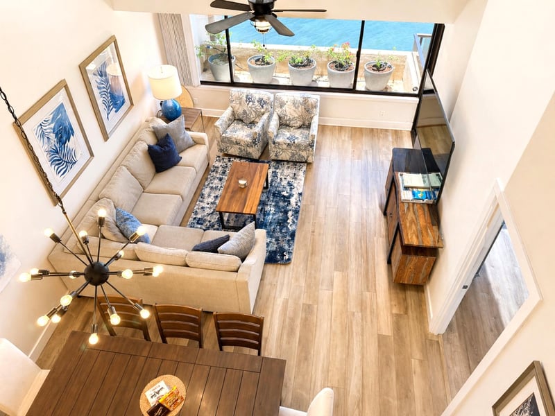 The updated, open concept living space features comfortable seating, perfect for entertaining or relaxing