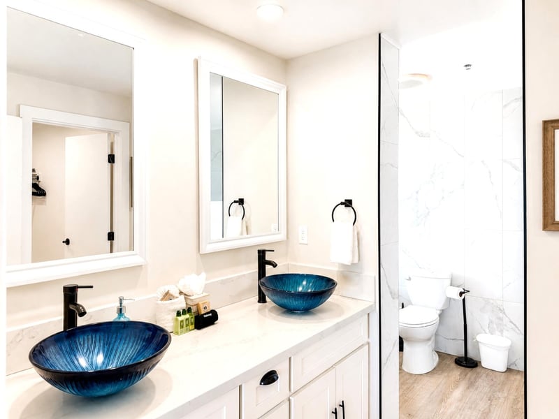 The primary bath features a dual vanity and clean, modern finishes throughout