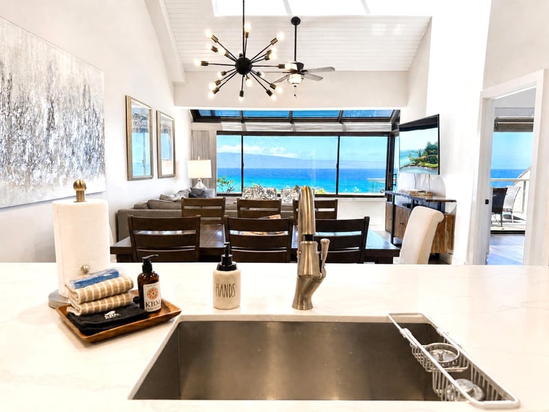 The kitchen opens to the dining and living areas, keeping the cook connected to guests and the view