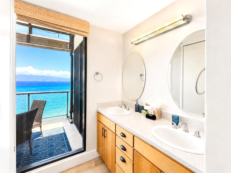 The dual sink vanity features ample counter space and ocean views
