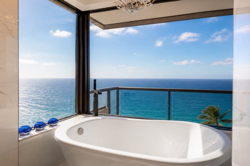 The primary bath offers a deep soaking tub with stunning ocean views