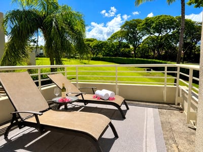 Relax on your private lanai with lush tropical views and comfortable lounge seating