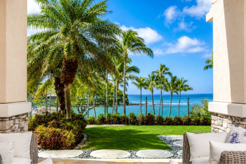 Beneath sunlit fronds and coastal calm, elegance meets ease