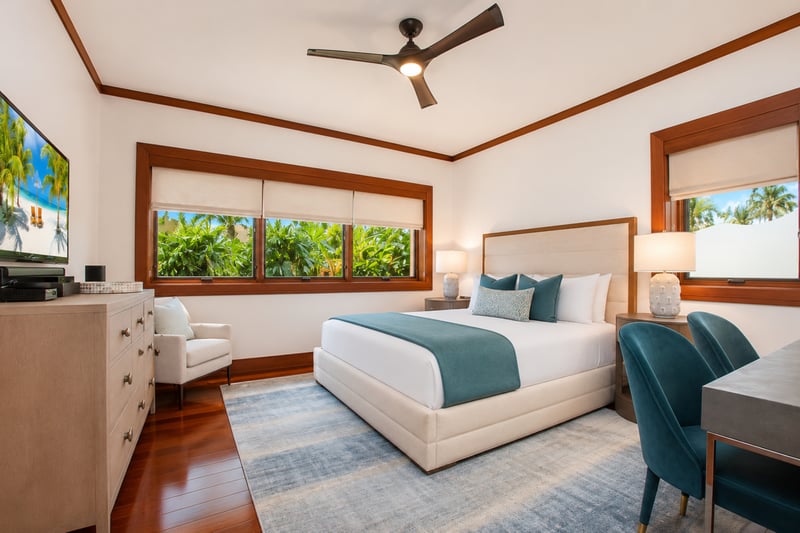 A serene bedroom welcomes you with clean, light colors and space for working if necessary