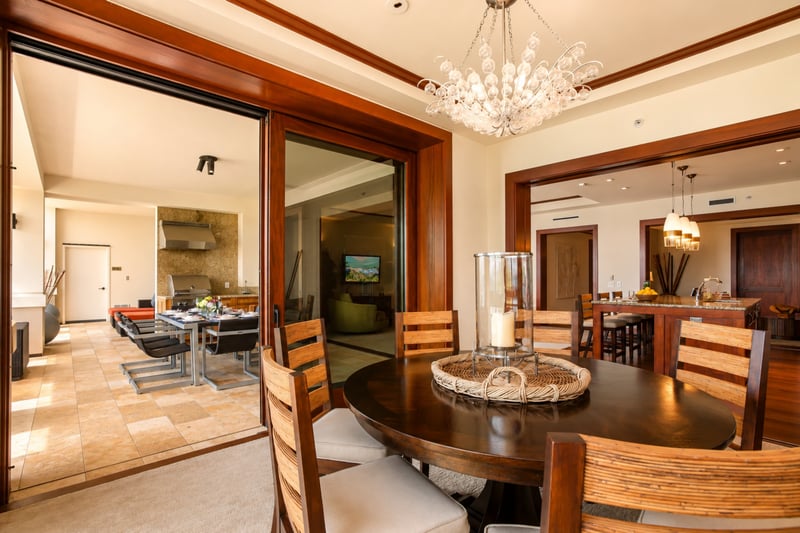 Chic dining room with glass doors opening to a breezy balcony MON-1303