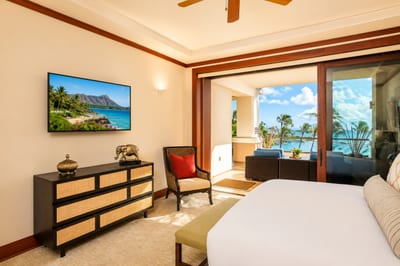 Spacious master suite with island-inspired decor and ample sunlight