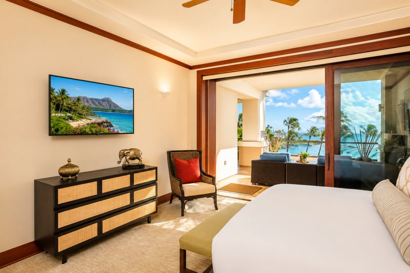 Spacious master suite with island-inspired decor and ample sunlight MON-1303