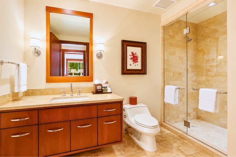 Clean and elegant, this bathroom includes a large glass walk in shower and soft lighting