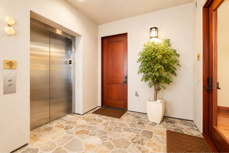 A spacious entry framed by island stonework and an elevator welcomes you to paradise MON-1303