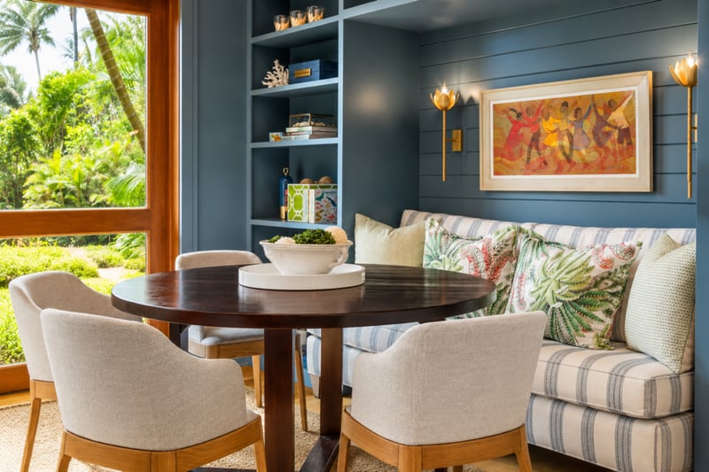 Den and library at The Resort at Kapalua Bay MON-2206 — striped banquette seating, built-in bookshelves, and a round dining table for four MON-2206