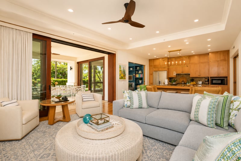 Living room at The Resort at Kapalua Bay MON-2206 — light sectional sofa opening directly to the chef's kitchen MON-2206