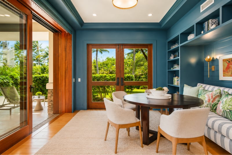 Den with garden access at The Resort at Kapalua Bay MON-2206 — French doors open to the lawn beside custom navy built-ins MON-2206
