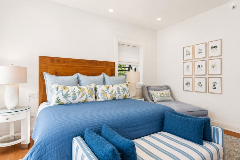 Guest bedroom at The Resort at Kapalua Bay MON-2206 — smart TV and console table with tropical window views MON-2206