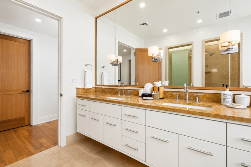 Guest bath vanity at The Resort at Kapalua Bay MON-2206 — mirrored medicine cabinet and direct hallway access
