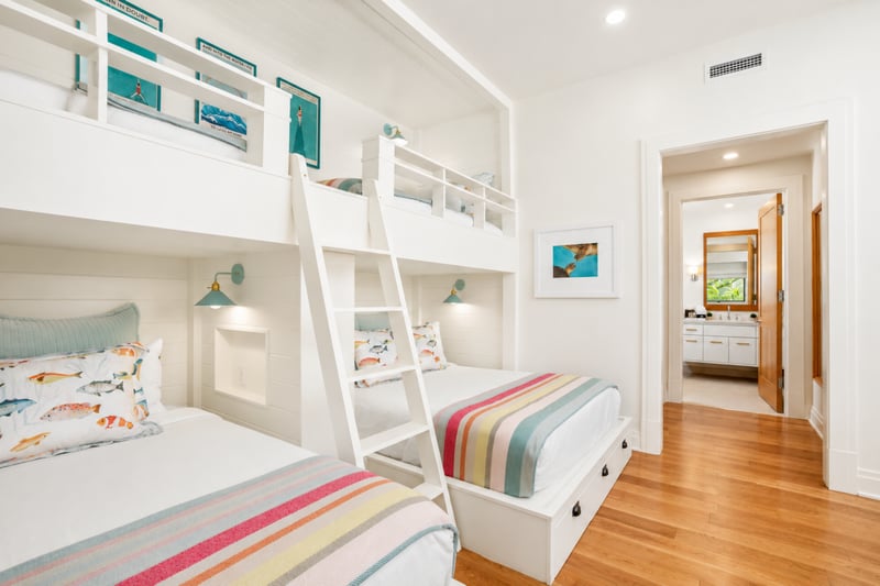 Kids' bunk room at The Resort at Kapalua Bay MON-2206 — triple bunks with playful fish-themed linens and an ensuite bath MON-2206