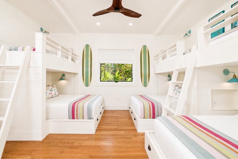 Kids' bunk room at The Resort at Kapalua Bay MON-2206 — two facing bunk sets with surfboard wall art and beach-stripe bedding MON-2206