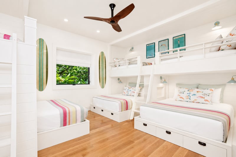 Kids' bunk room at The Resort at Kapalua Bay MON-2206 — colorful striped linens across three lower beds beneath the bunks MON-2206