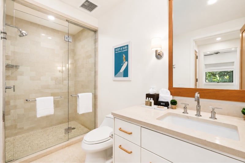 Kids' bathroom at The Resort at Kapalua Bay MON-2206 — glass shower and playful surf-themed wall art