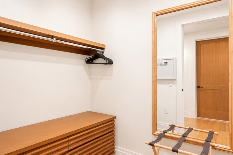 Walk-in closet at The Resort at Kapalua Bay MON-2206 — ample hanging storage, a dresser, and luggage rack for extended stays MON-2206