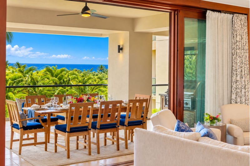 Lanai dining with ocean horizon views, framed by sliding doors to the great room
