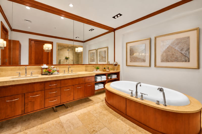 Primary bathroom with dual sink vanity, soaking tub, and ample mirror space