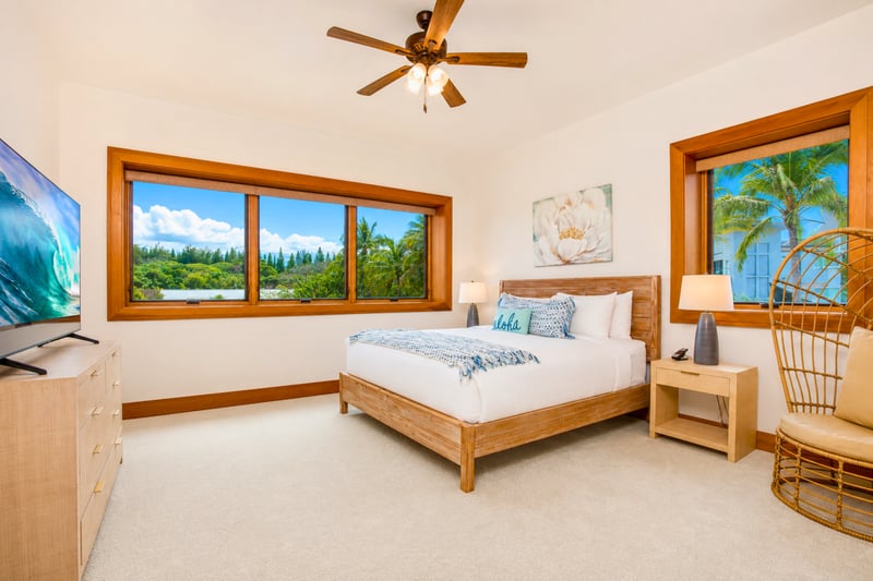 Guest bedroom at The Resort at Kapalua Bay MON-6301 — king bed with palm-framed ocean views and smart TV